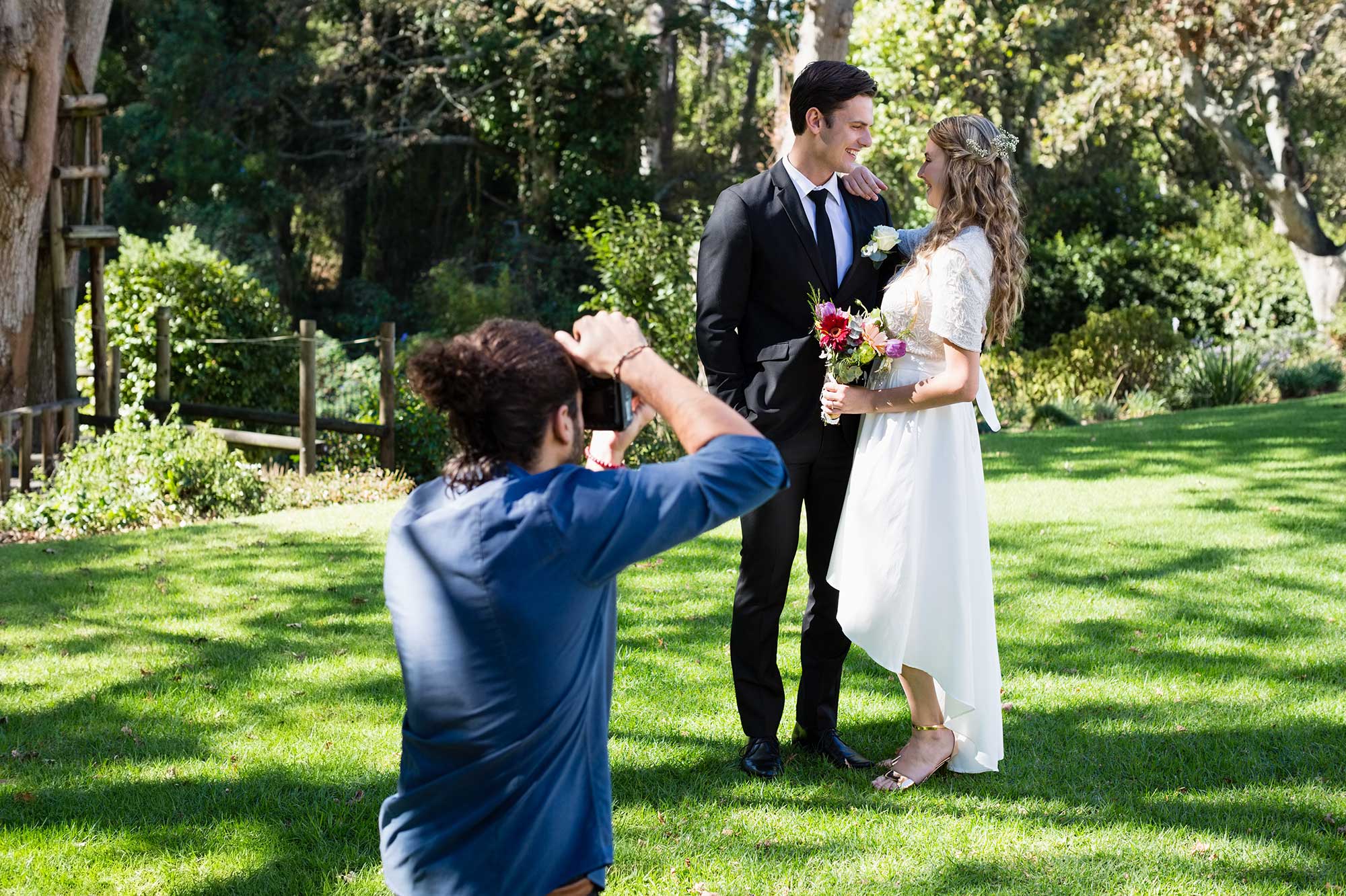 Photographer capturing a tender moment between the bride and groom