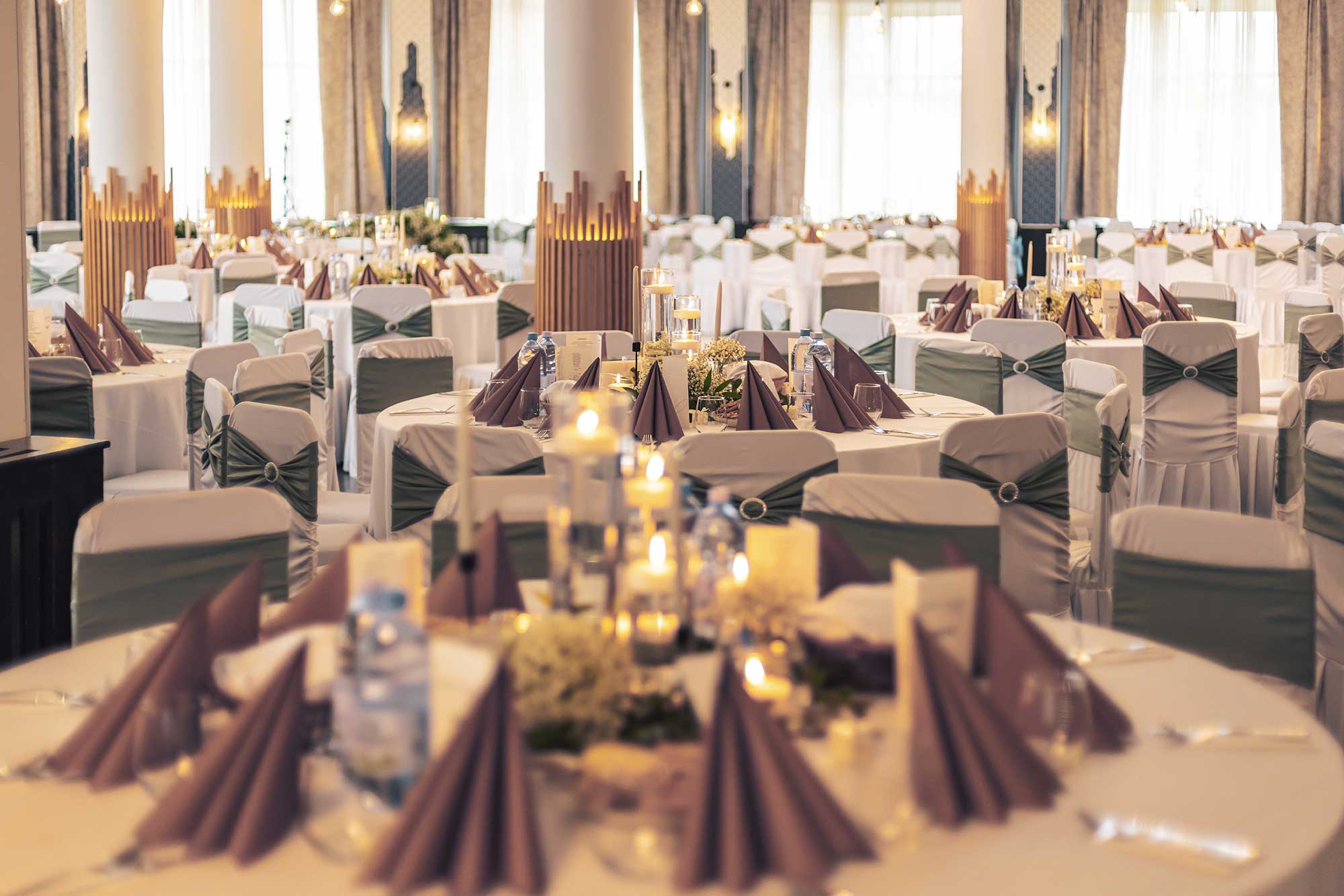 A beautifully decorated event space with ambient lighting, setting the stage for a memorable corporate event
