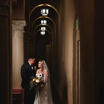 bride and groom standing in a hallway